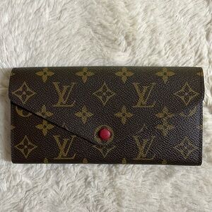 Authentic Louis Vuitton monogram wallet with red interior. Preowned.
